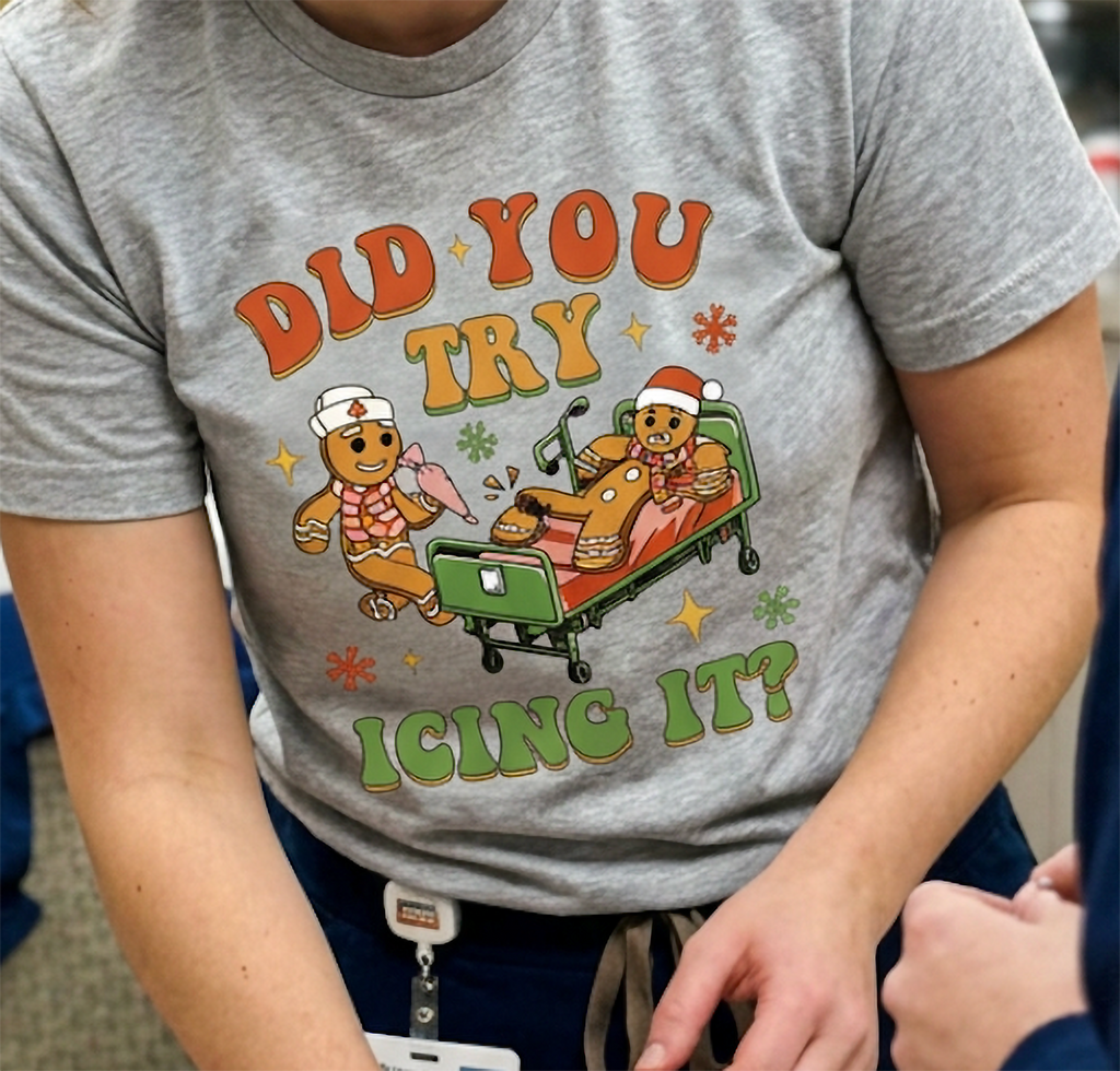 Close-up of Did You Try Icing It gingerbread Christmas graphic printed on a heather gray unisex t-shirt.