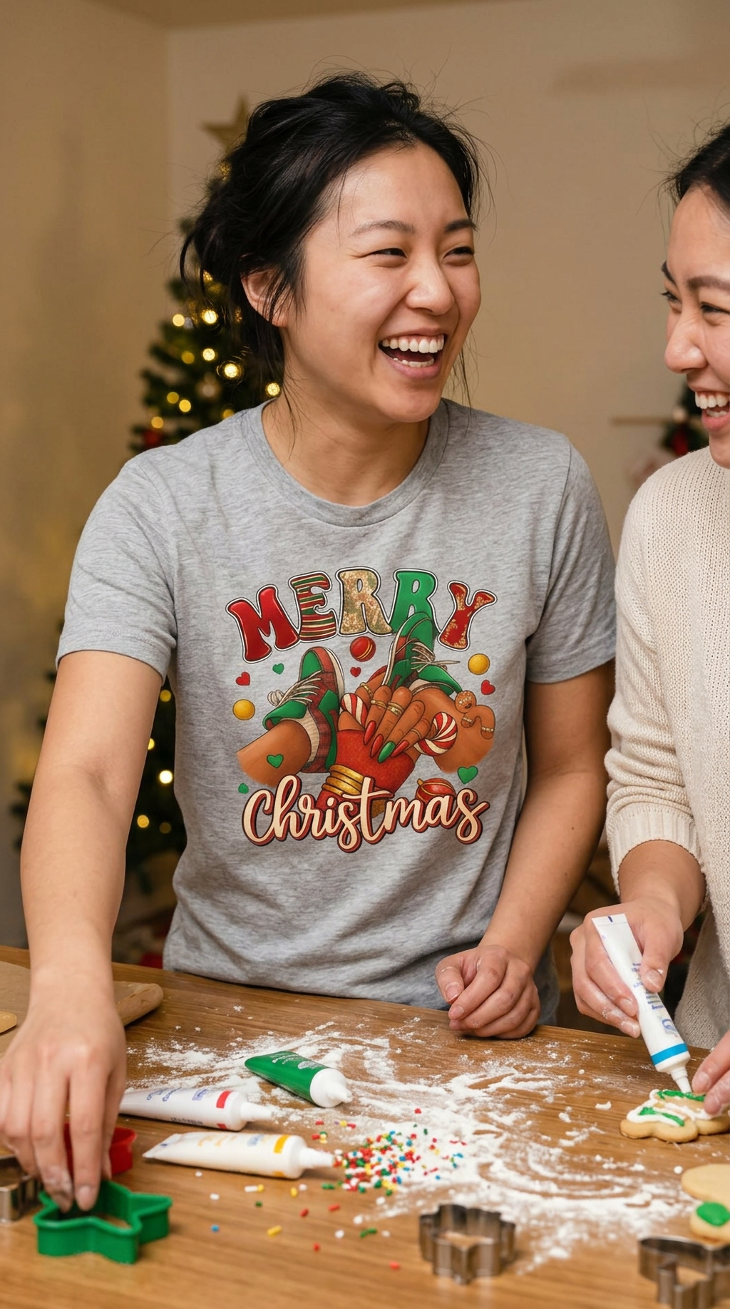 Lifestyle – Heather Gray: Woman wearing a heather gray Merry Christmas sneaker graphic shirt during a casual holiday celebration.