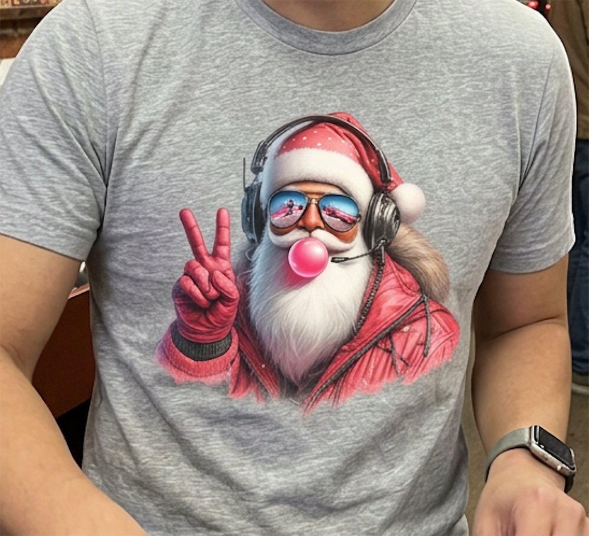 Heather Gray Design Close-Up: Close-up of heather gray Christmas graphic tee featuring a cool Santa Claus with reflective sunglasses, headset, pink bubblegum, and a peace sign.