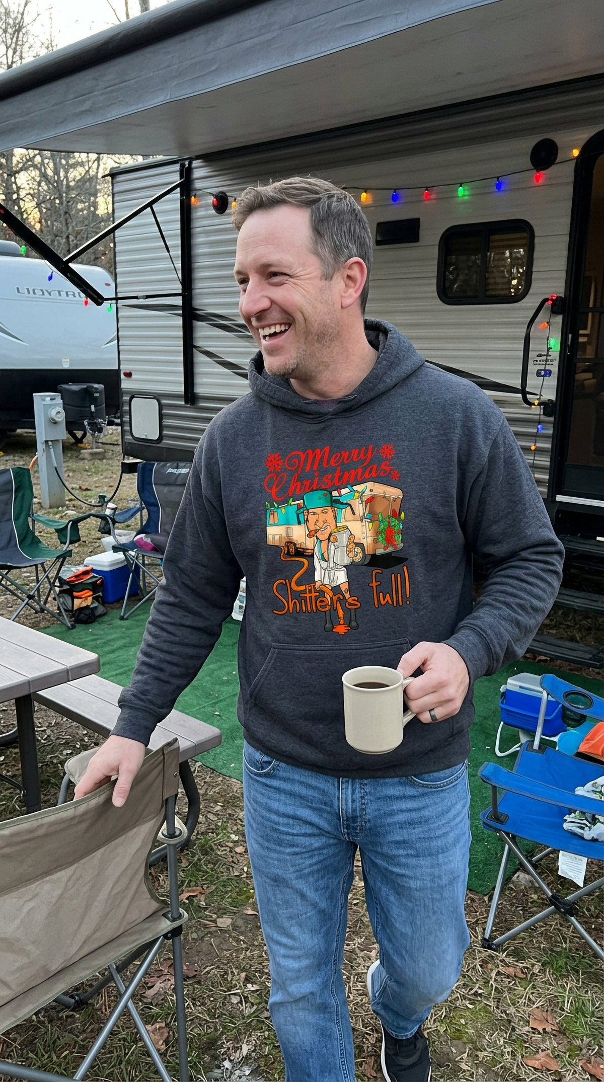 Man wearing gray Shitter’s Full Cousin Eddie Christmas hoodie outdoors