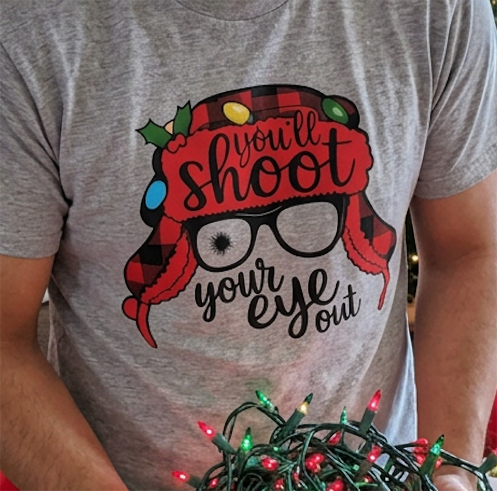 Close-up of heather gray Christmas t-shirt featuring nostalgic holiday quote and colorful festive artwork