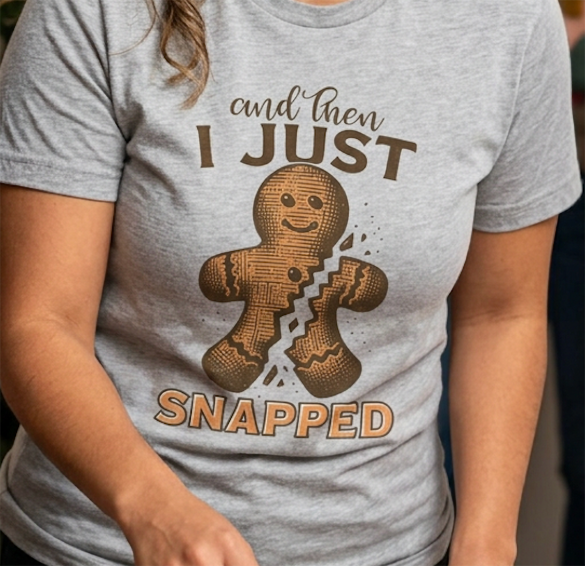 Heather Gray Close-Up: Detailed view of the sarcastic gingerbread Christmas graphic on a heather gray t-shirt.