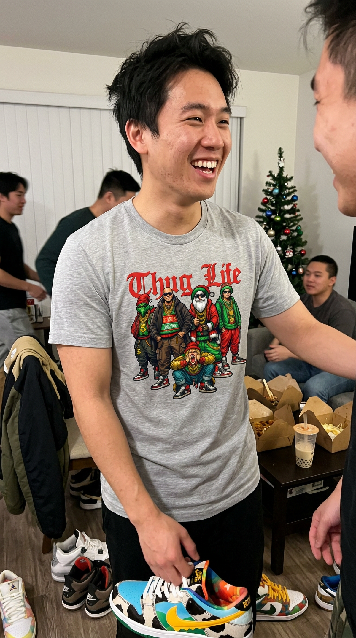 Man wearing heather gray Thug Life Christmas t-shirt at an indoor holiday gathering