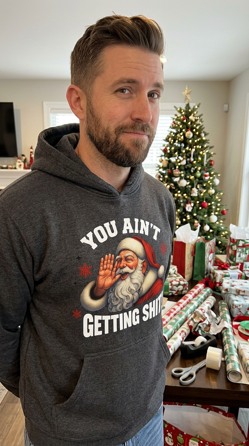 Man wearing gray You Ain’t Getting Shit Santa hoodie at a Christmas gathering