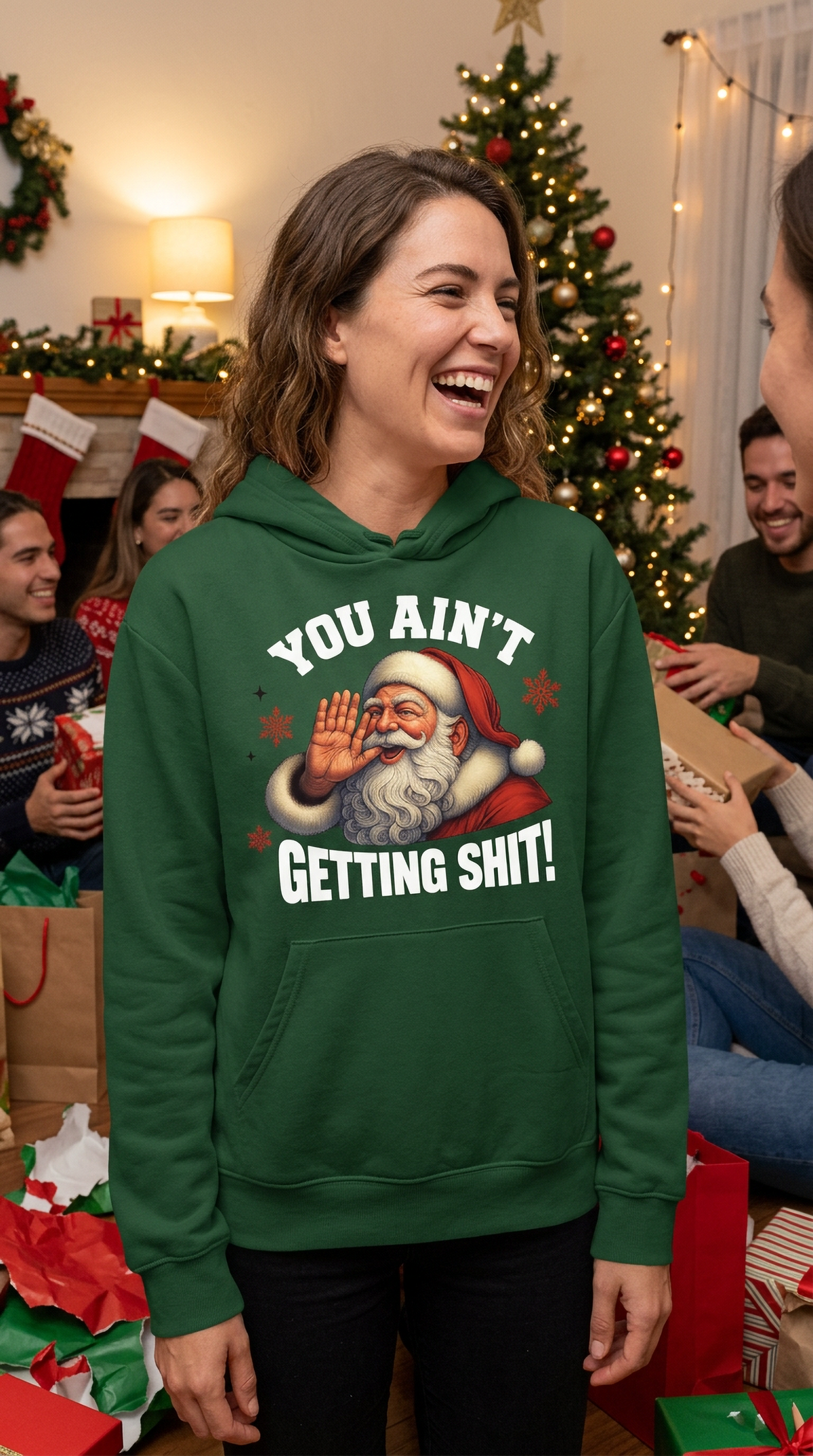 Woman wearing forest green You Ain’t Getting Shit Santa hoodie at a holiday gathering