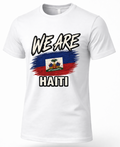 A white short-sleeve crewneck t-shirt featuring a graphic print of the Haitian flag with a brushstroke effect and the words 'WE ARE' above and 'HAITI' below in bold black-and-white lettering.