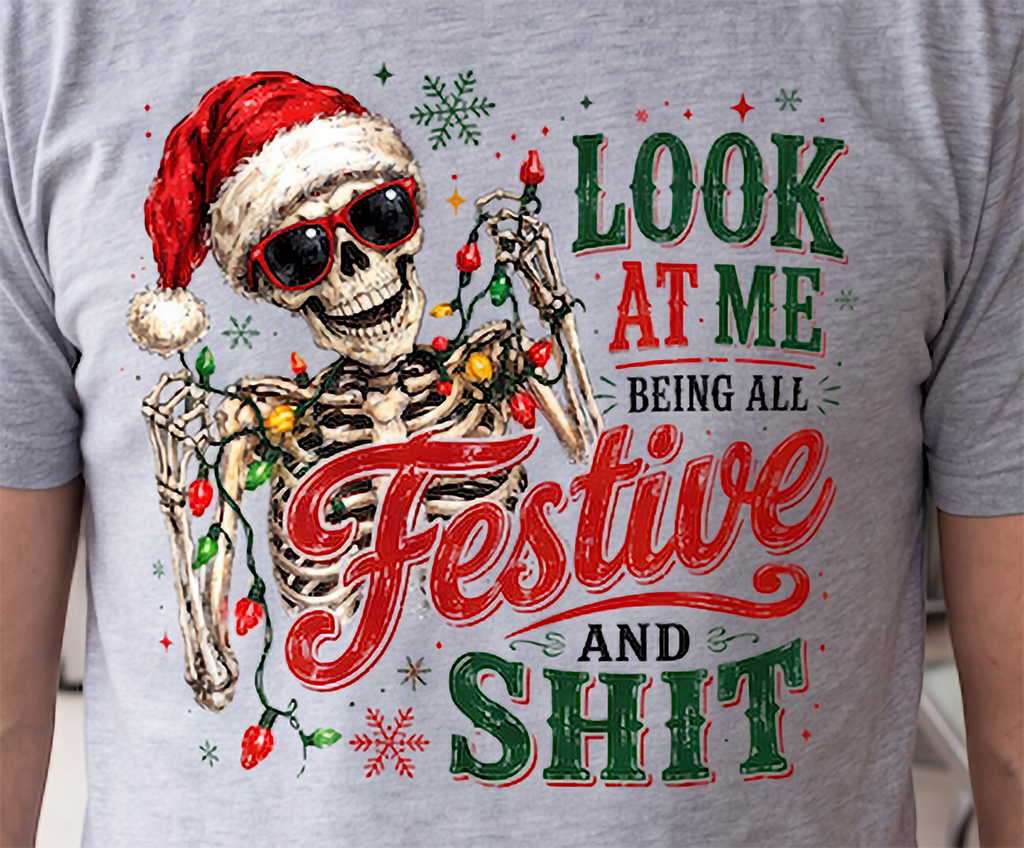 Heather gray close-up: Close-up of Santa skeleton and colorful Christmas lights graphic printed on heather gray shirt.