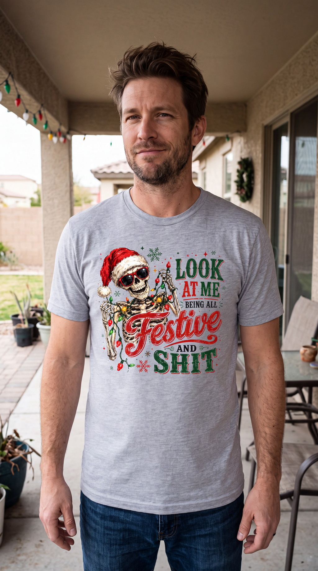 Heather Gray lifestyle close-up: Man modeling heather gray sarcastic Christmas graphic tee featuring festive skeleton and holiday lights.