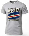 A heather gray short-sleeve t-shirt with a graphic print of the Cabo Verde flag and the text 'WE ARE CABO VERDE' in white with black outlines.