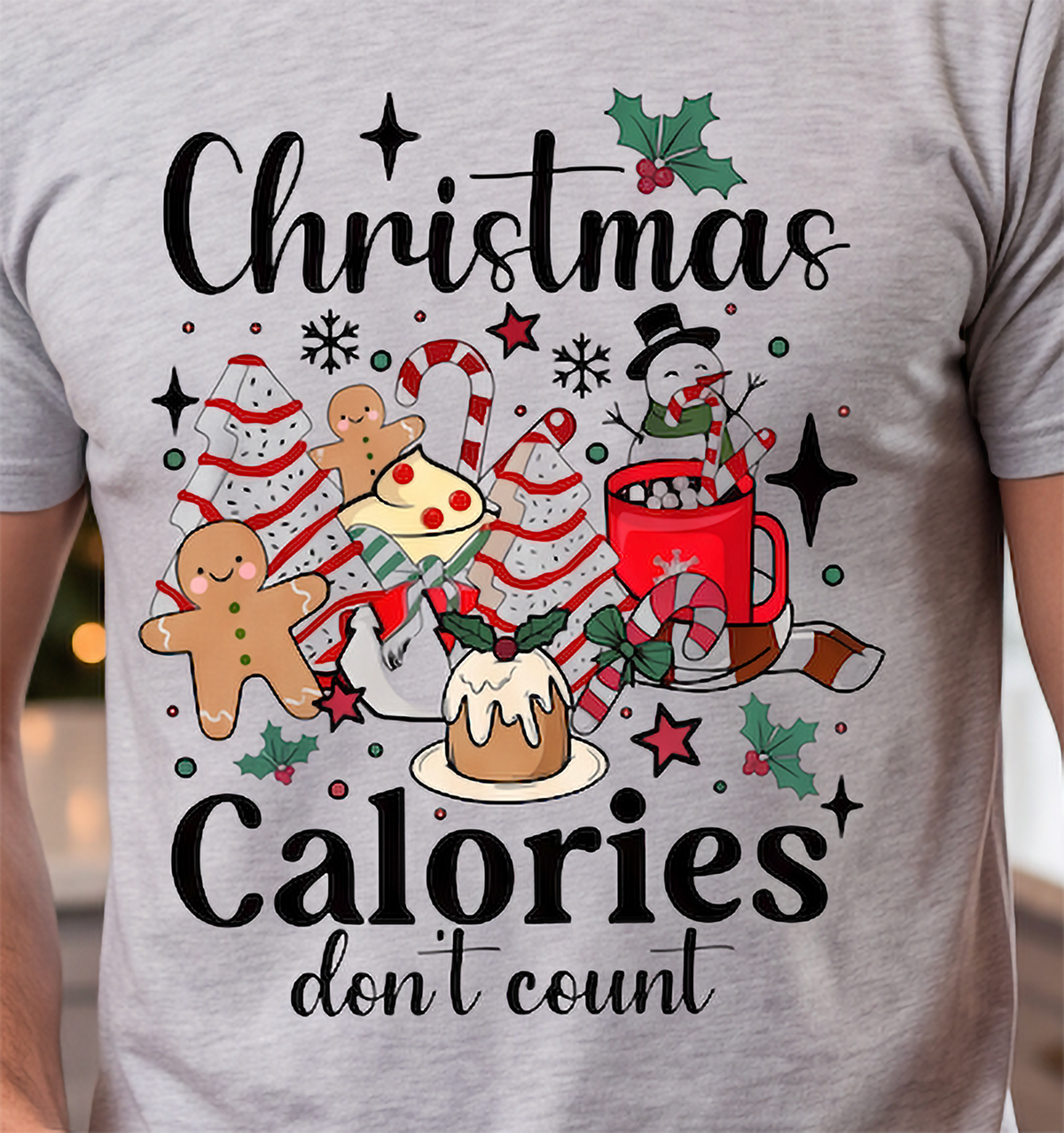 Close-up of heather gray Christmas Calories Don’t Count tee featuring colorful festive food artwork.