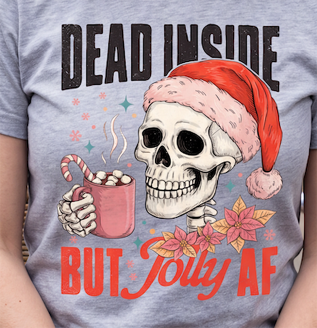 Close-up of Dead Inside But Jolly AF skeleton Christmas design printed on heather gray shirt.