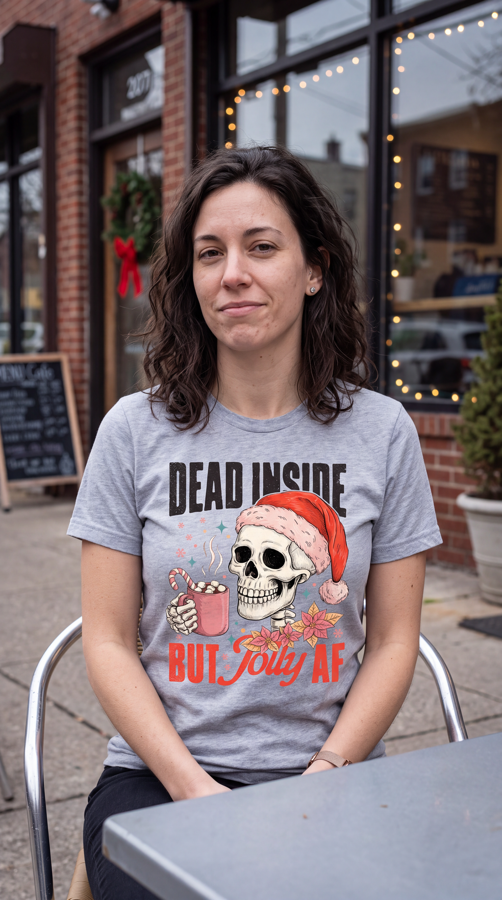Woman wearing heather gray Dead Inside But Jolly AF Christmas graphic tee.