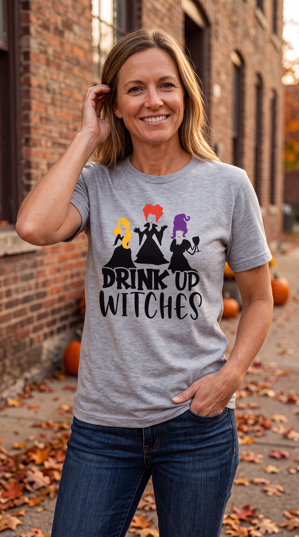 Woman wearing heather gray Drink Up Witches Hocus Pocus Halloween shirt