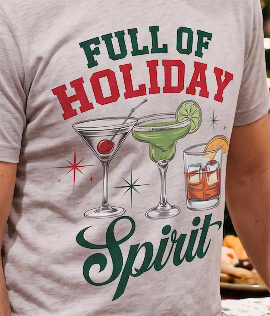 Close-up of Full of Holiday Spirit Christmas cocktail graphic on heather gray shirt.