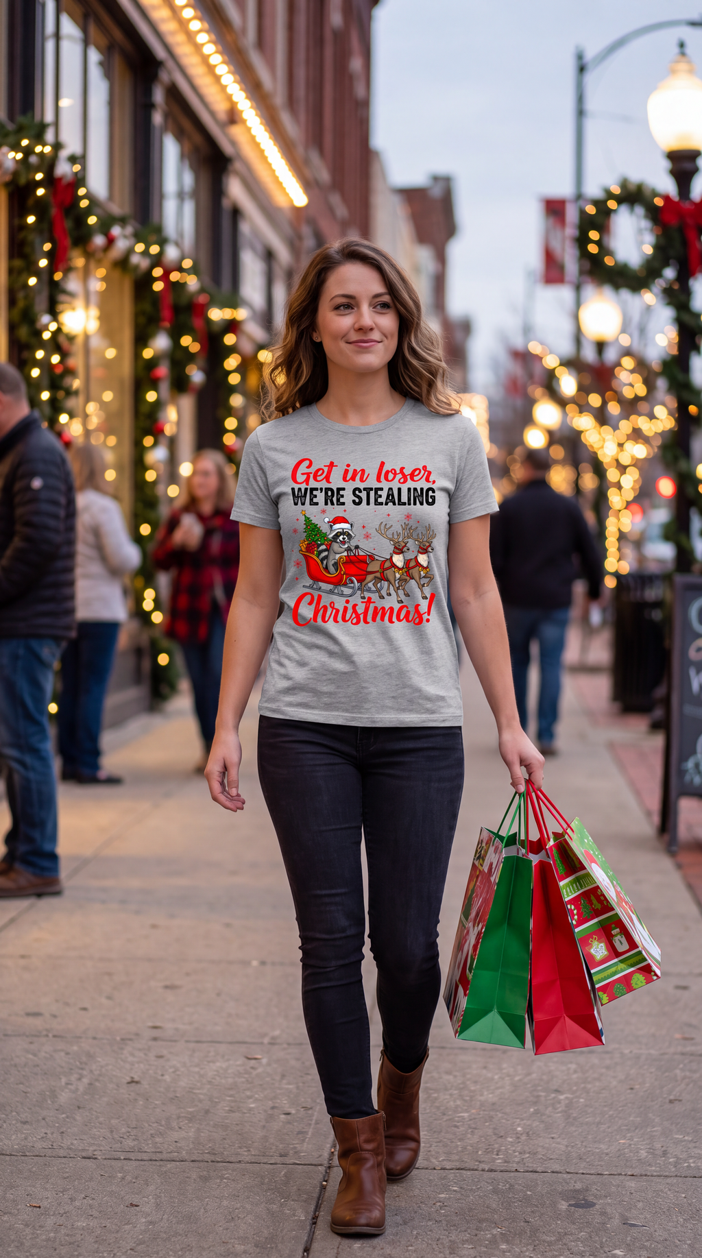 Woman wearing a heather gray Get in Loser We’re Stealing Christmas shirt while holiday shopping.