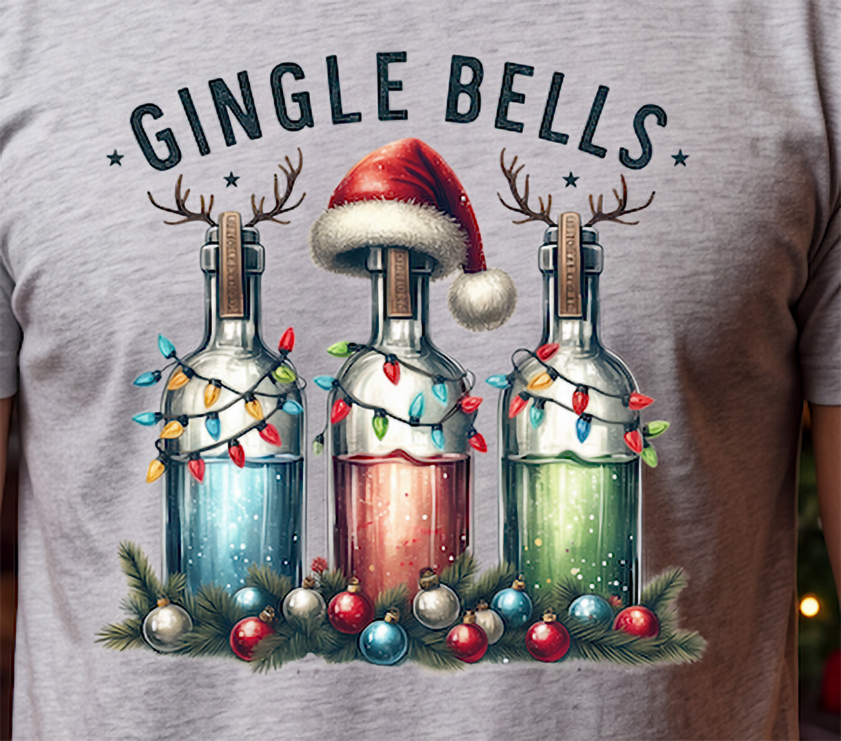 Close-up of Gingle Bells festive Christmas liquor bottle artwork on heather gray shirt