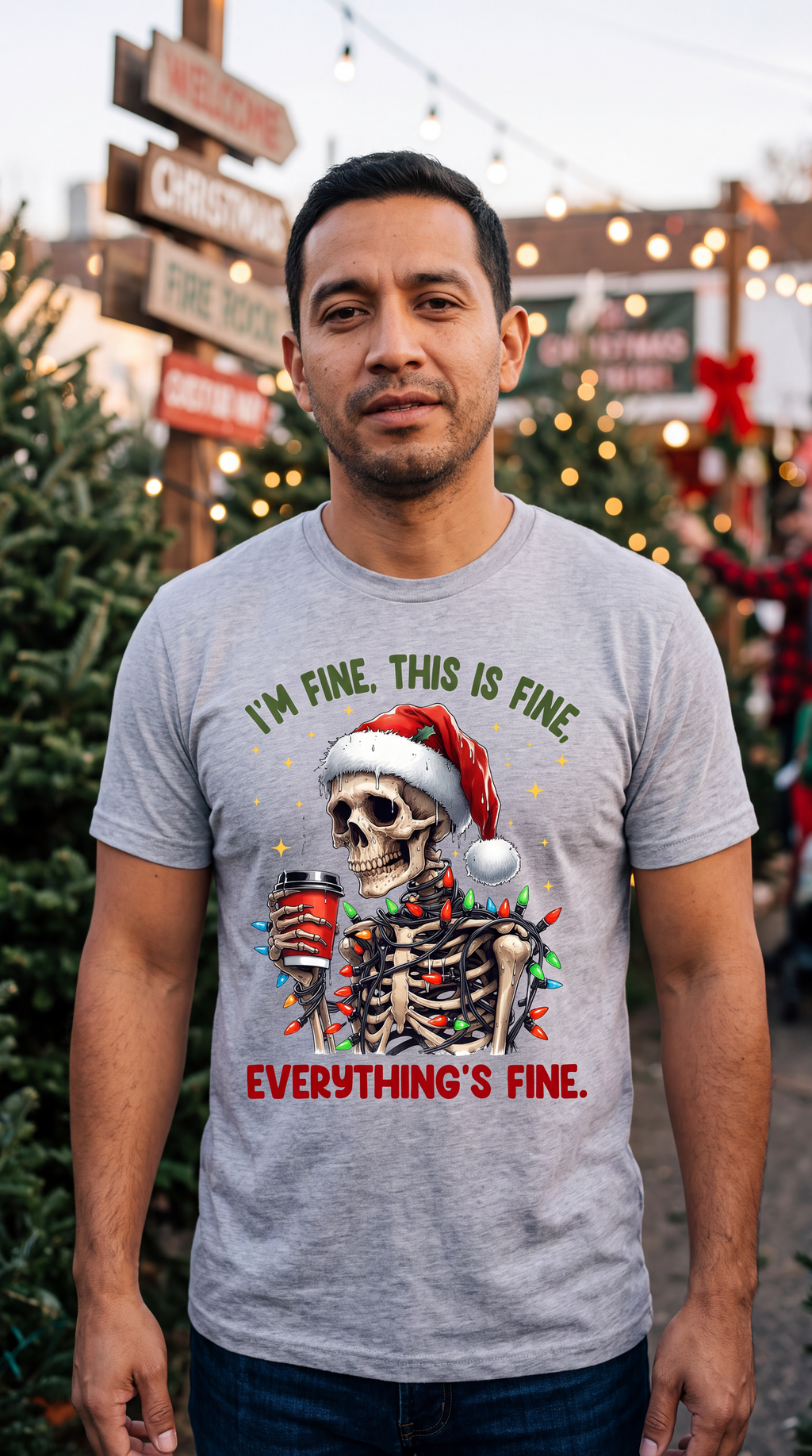 Man wearing heather gray I’m Fine Everything’s Fine skeleton Christmas shirt in a festive holiday setting.