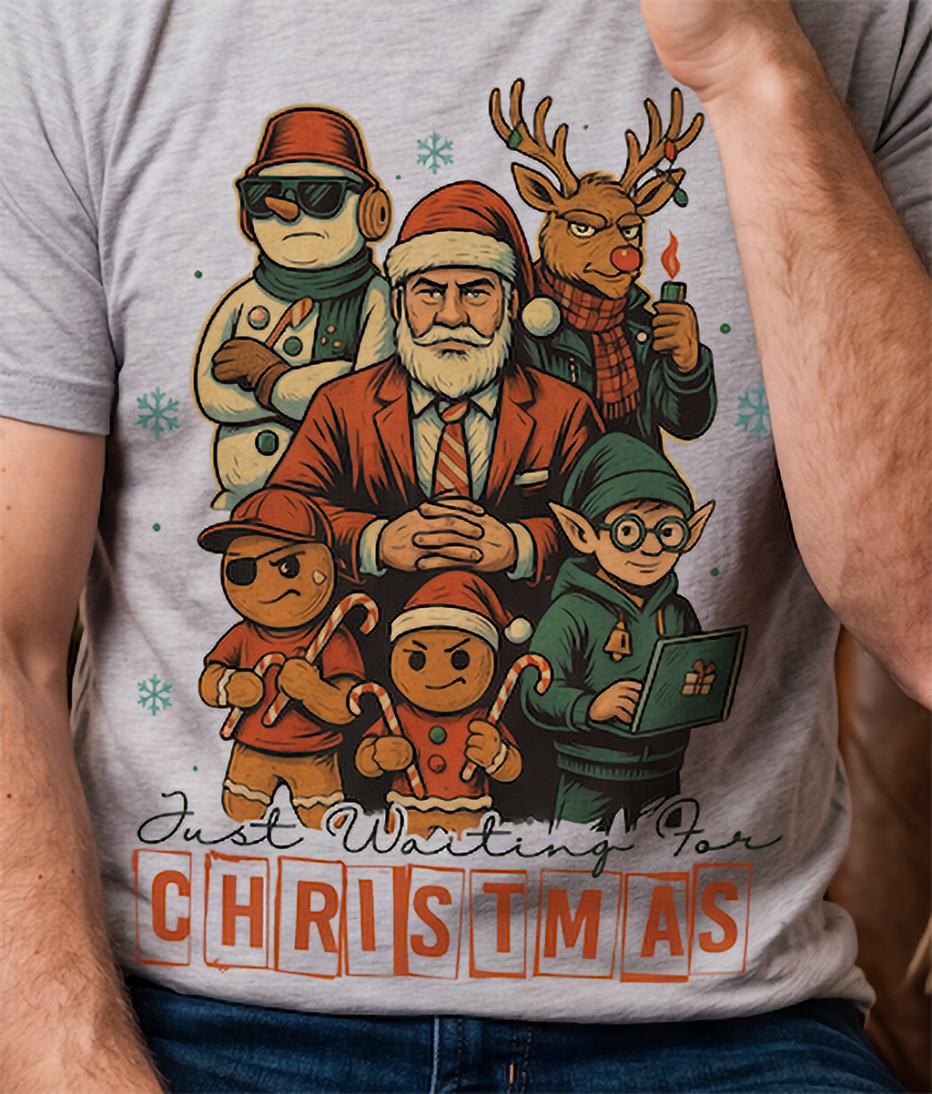 Close-up of heather gray funny Christmas shirt featuring colorful Santa, reindeer, elf, snowman and gingerbread artwork.