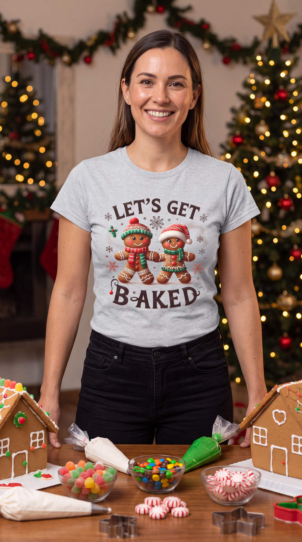 Woman wearing gray Let’s Get Baked Christmas graphic shirt with festive gingerbread design.