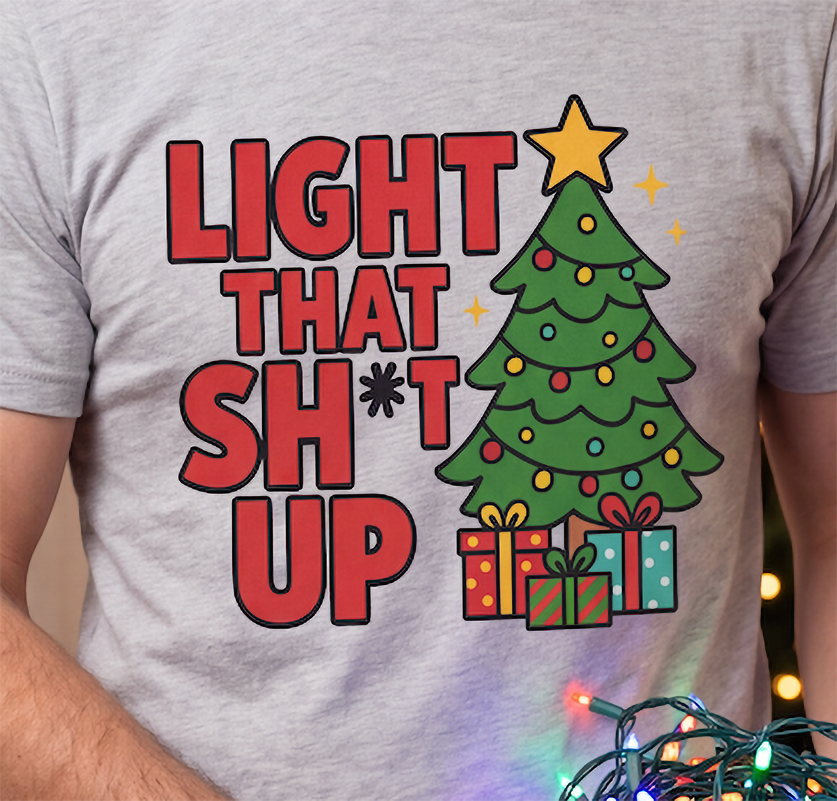 Close-up of heather gray Light That Shit Up Christmas shirt showing Christmas tree and presents design.
