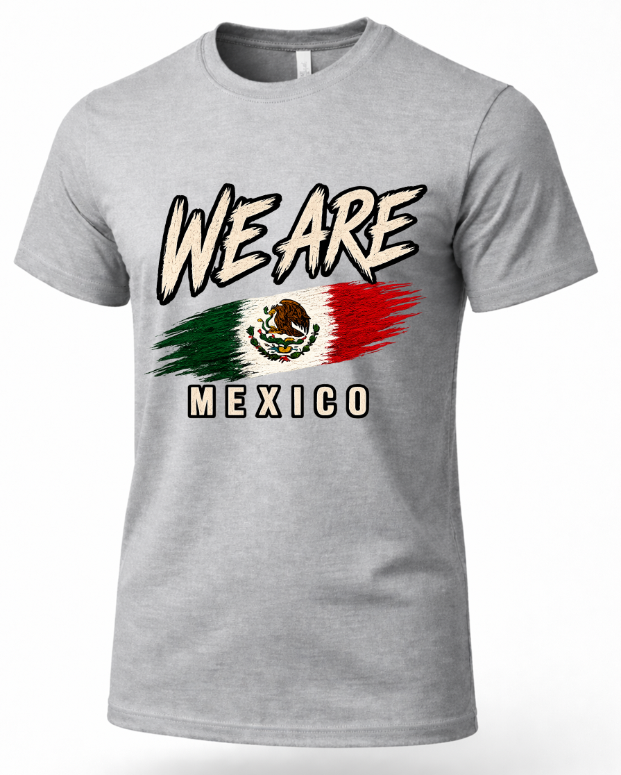 A heather gray short-sleeve crewneck t-shirt featuring a graphic print of the Mexican flag with the text 'WE ARE' above and 'MEXICO' below.