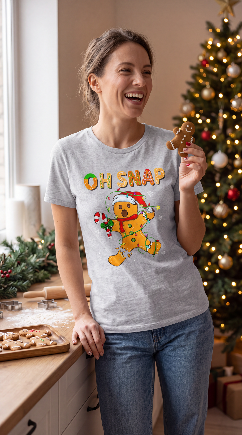 Person wearing heather gray Oh Snap gingerbread Christmas graphic T-shirt.