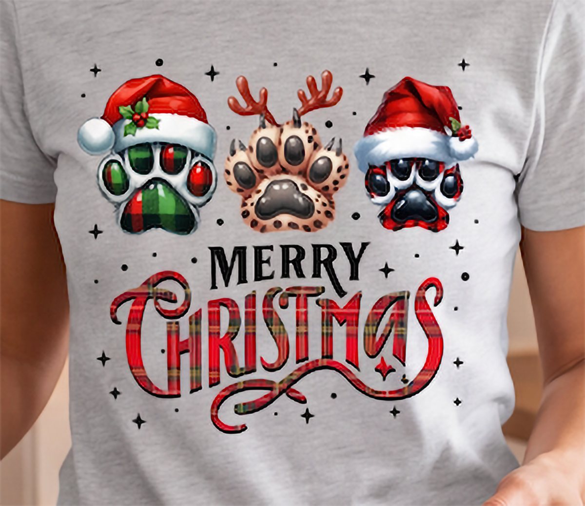 Close-up of heather gray Merry Christmas dog shirt featuring three Christmas paw prints and red lettering.