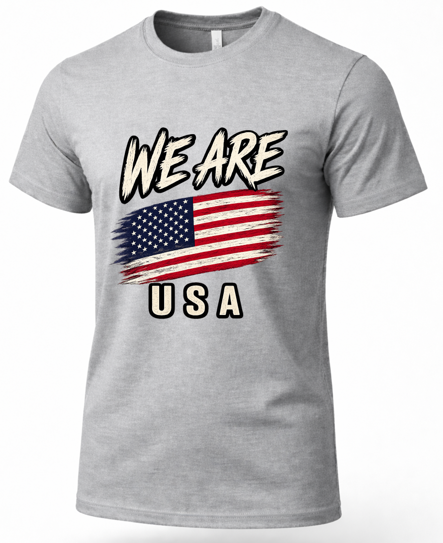 A heather gray short-sleeve crewneck t-shirt featuring a distressed graphic print on the front with the text 'WE ARE' above an American flag and 'USA' below.