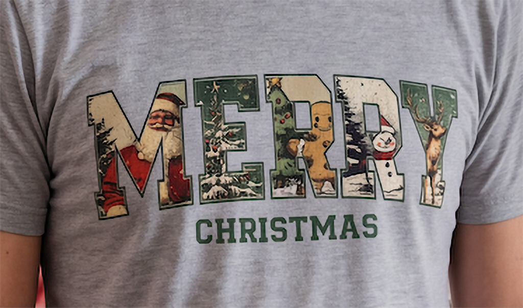 Close-up of heather gray Vintage Merry Christmas shirt featuring Santa, gingerbread man, snowman and reindeer.