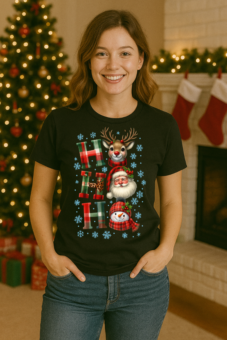 Woman wearing a black Ho Ho Ho Christmas t-shirt with Santa, reindeer, and snowman graphic in a festive holiday living room setting.