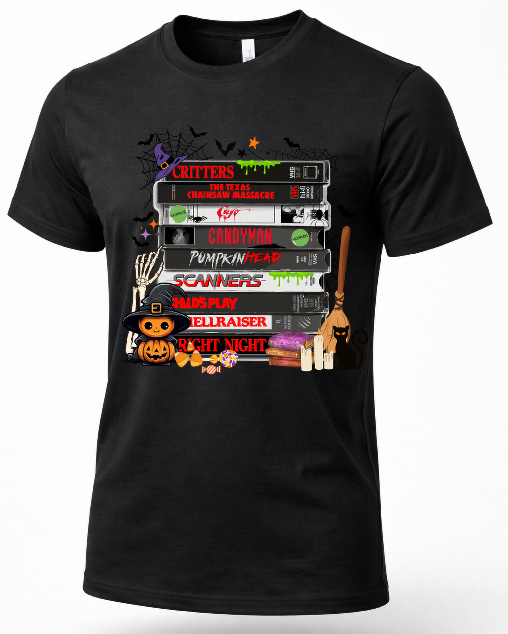 A black short-sleeve crewneck t-shirt featuring a colorful graphic print of stacked VHS tapes and Halloween-themed illustrations on a white background.