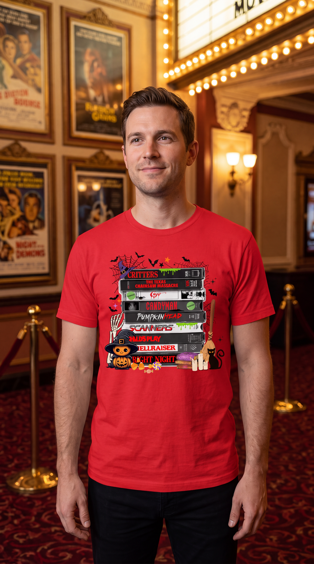 Man wearing a red horror movie VHS T-shirt featuring stacked retro scary movie tapes with spooky Halloween graphics.