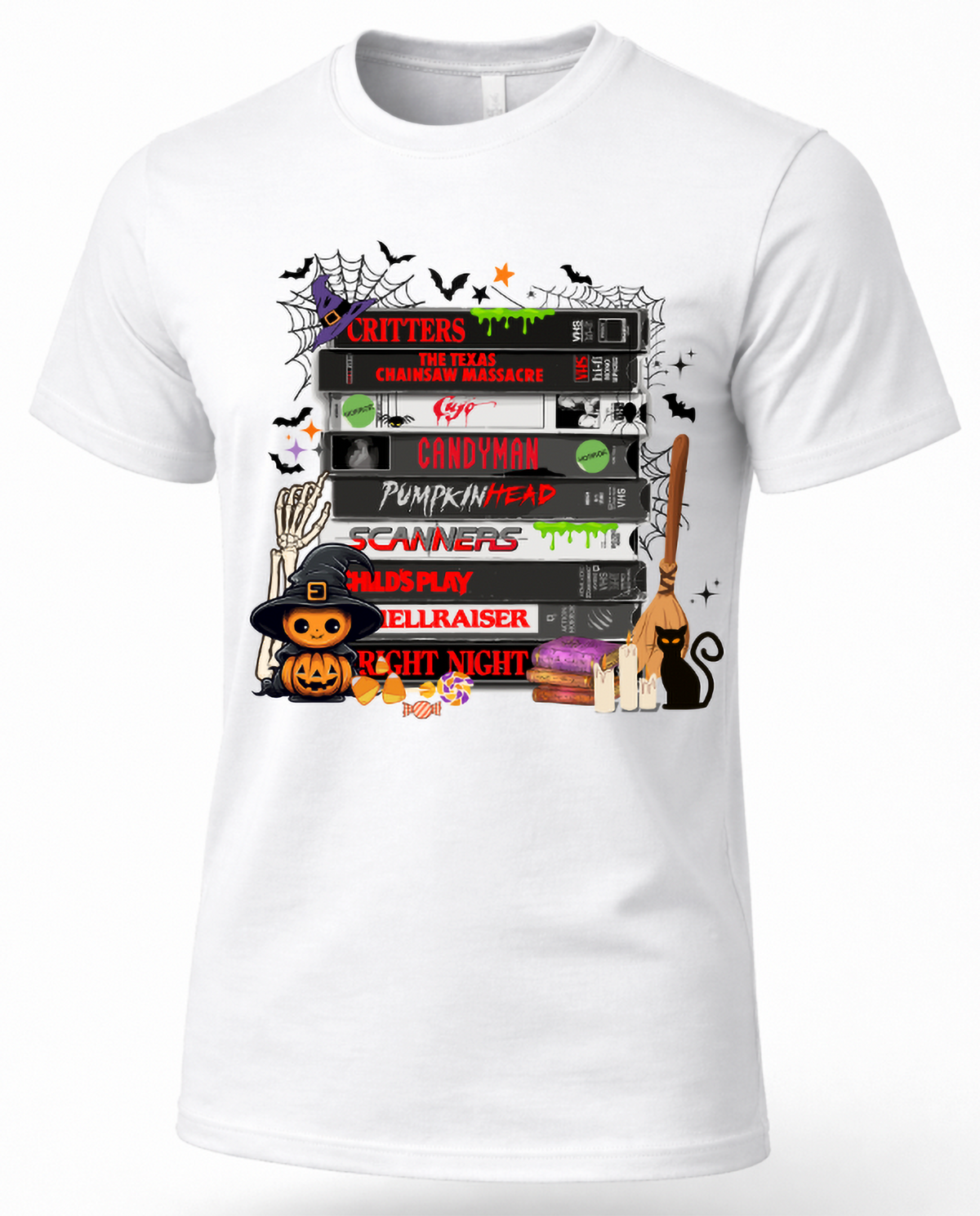White retro horror movie VHS T-shirt featuring stacked scary movie tapes, bats, spiderwebs, witch hat, pumpkin, candy and black cat.