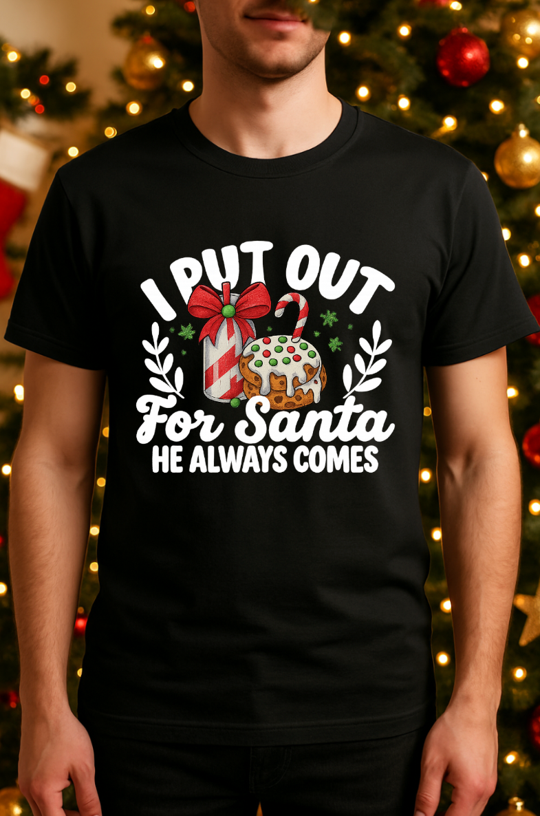 Man wearing a black Bella + Canvas 3001 unisex t-shirt with “I Put Out for Santa” funny Christmas graphic, adult humor holiday shirt displayed in front of a festive Christmas tree