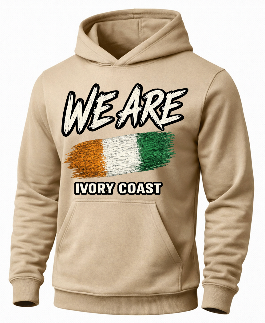 A beige pullover hoodie with a graphic on the chest that reads 'WE ARE' above a horizontal tricolor stripe in gold, white, and green, with 'IVORY COAST' below in white text with a black outline.