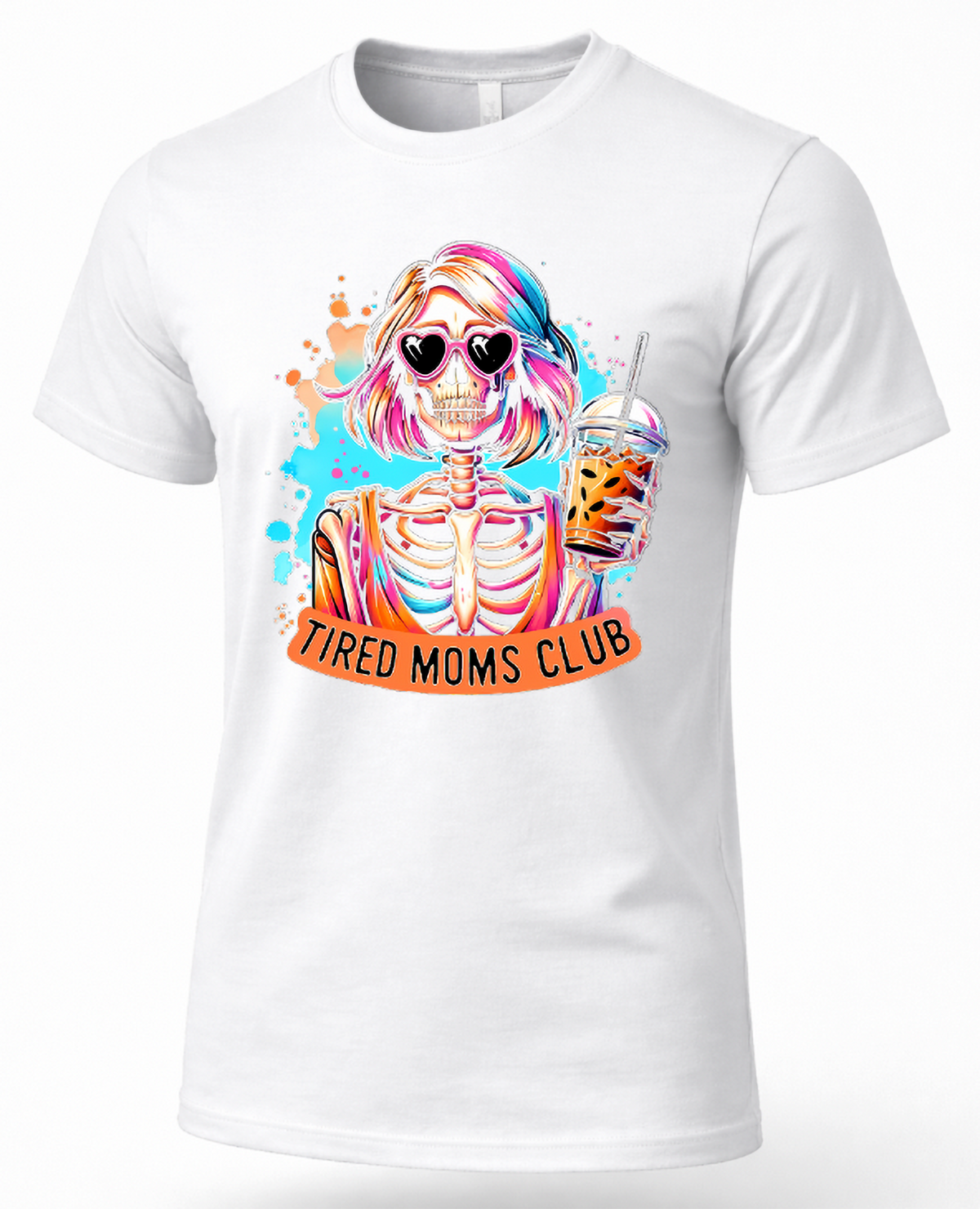 A white short-sleeve crewneck t-shirt featuring a colorful graphic of a skeleton woman with pink hair, heart-shaped sunglasses, and a drink, with an orange banner below reading 'TIRED MOMS CLUB'.