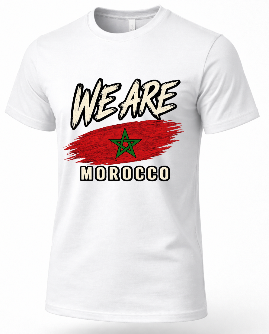 A white short-sleeve crewneck t-shirt featuring a graphic print of the Moroccan flag with a red brushstroke background and a green star, with the text 'WE ARE MOROCCO' in black and white outlined lettering.