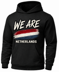 A black pullover hoodie with a front graphic that reads 'WE ARE' above a red, white, and blue brushstroke design, and 'NETHERLANDS' below in white text.