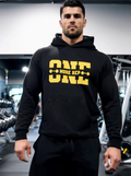 Man wearing black gym hoodie with “One More Rep” weightlifting quote in fitness gym