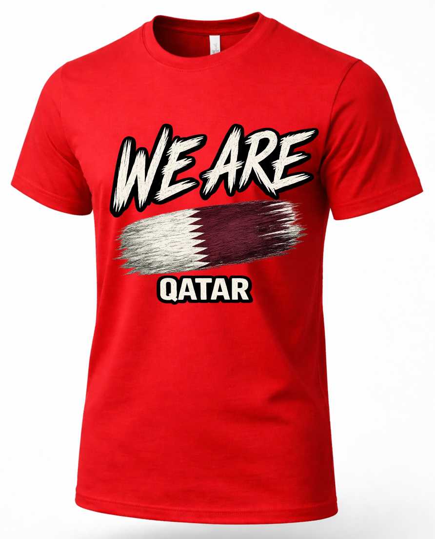 A red short-sleeve crewneck t-shirt featuring a graphic print of the word 'WE ARE' in a stylized white and black font, an abstract brushstroke design in the colors of the Qatar flag, and the word 'QATAR' below it.