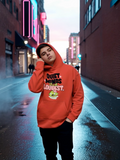 Person wearing orange “Quiet Minds Think Loudest” graphic hoodie in a city street at night
