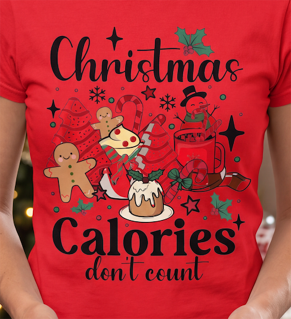 Close-up of red Christmas Calories Don’t Count graphic tee featuring colorful holiday food artwork.