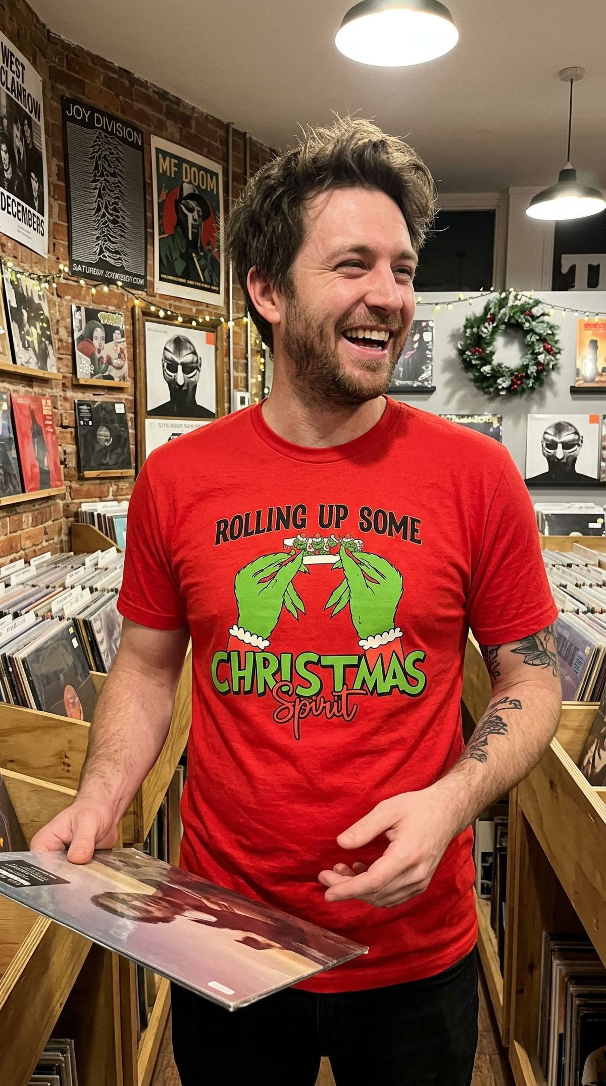 Man wearing red Rolling Up Some Christmas Spirit graphic t-shirt while shopping inside a store