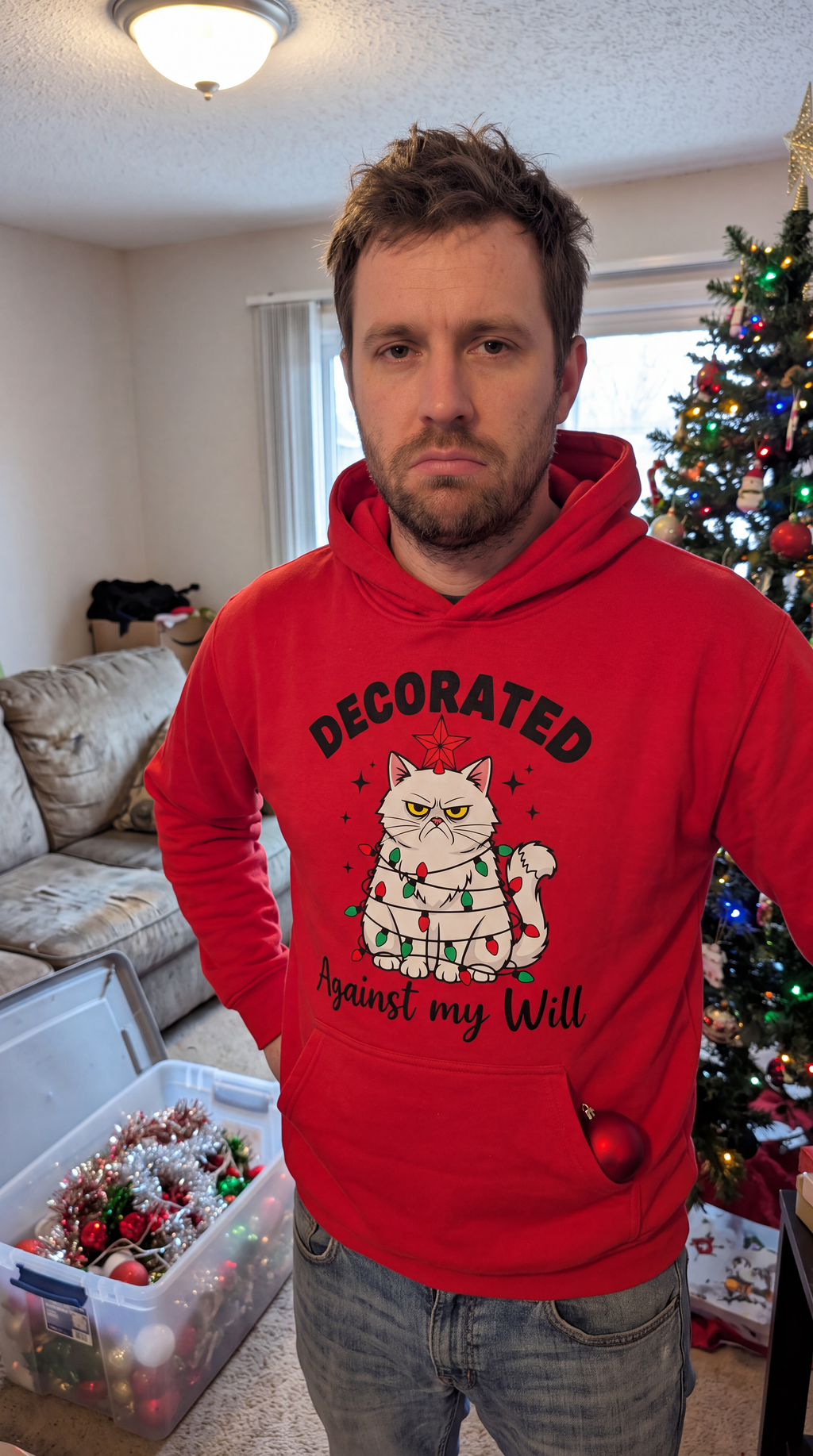 Man wearing red funny cat Christmas hoodie with Decorated Against My Will design