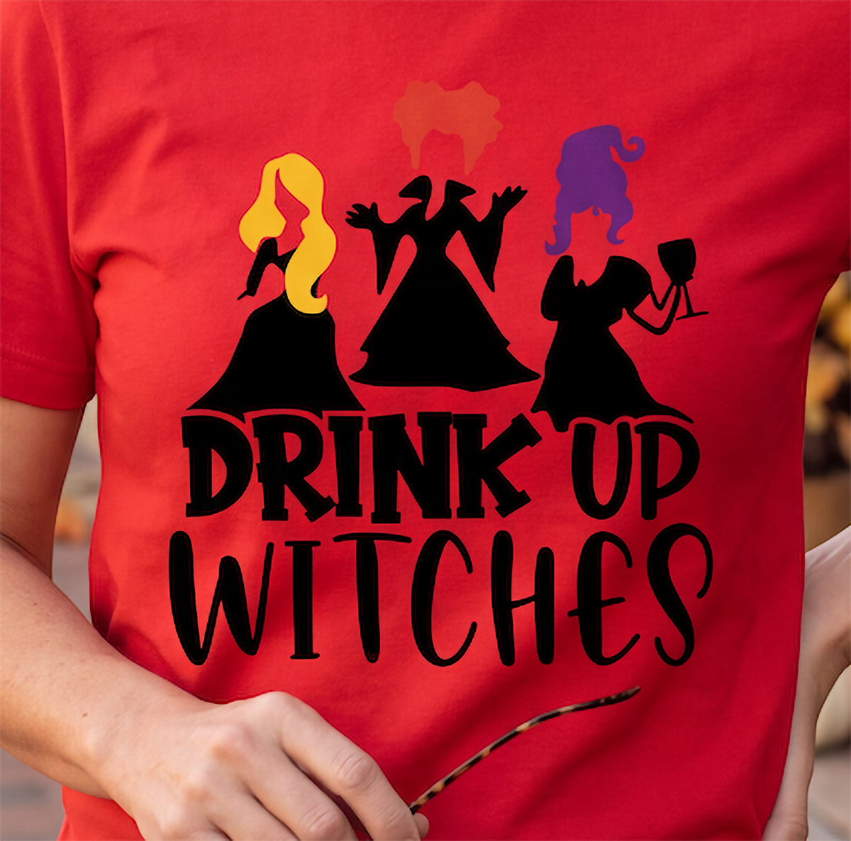 Close-up of red Drink Up Witches Halloween shirt with colorful witch design