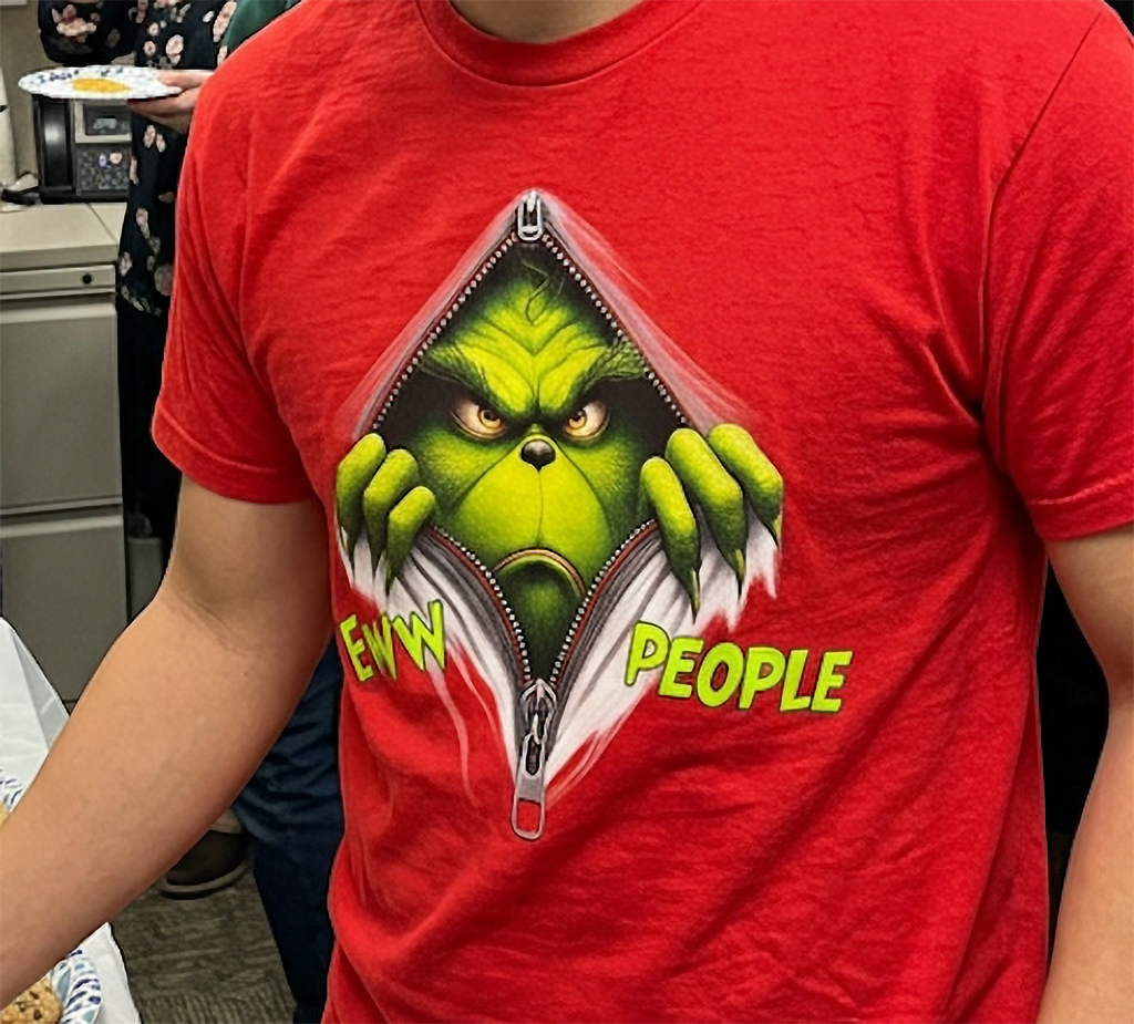 Red Close-Up: Close-up of the bright green Eww People Grinch Christmas graphic printed on a red shirt.