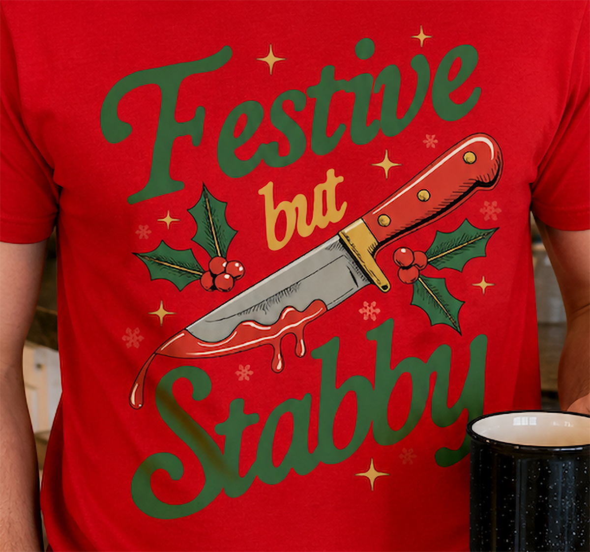 Close-up of Festive But Stabby knife and holly design on red shirt