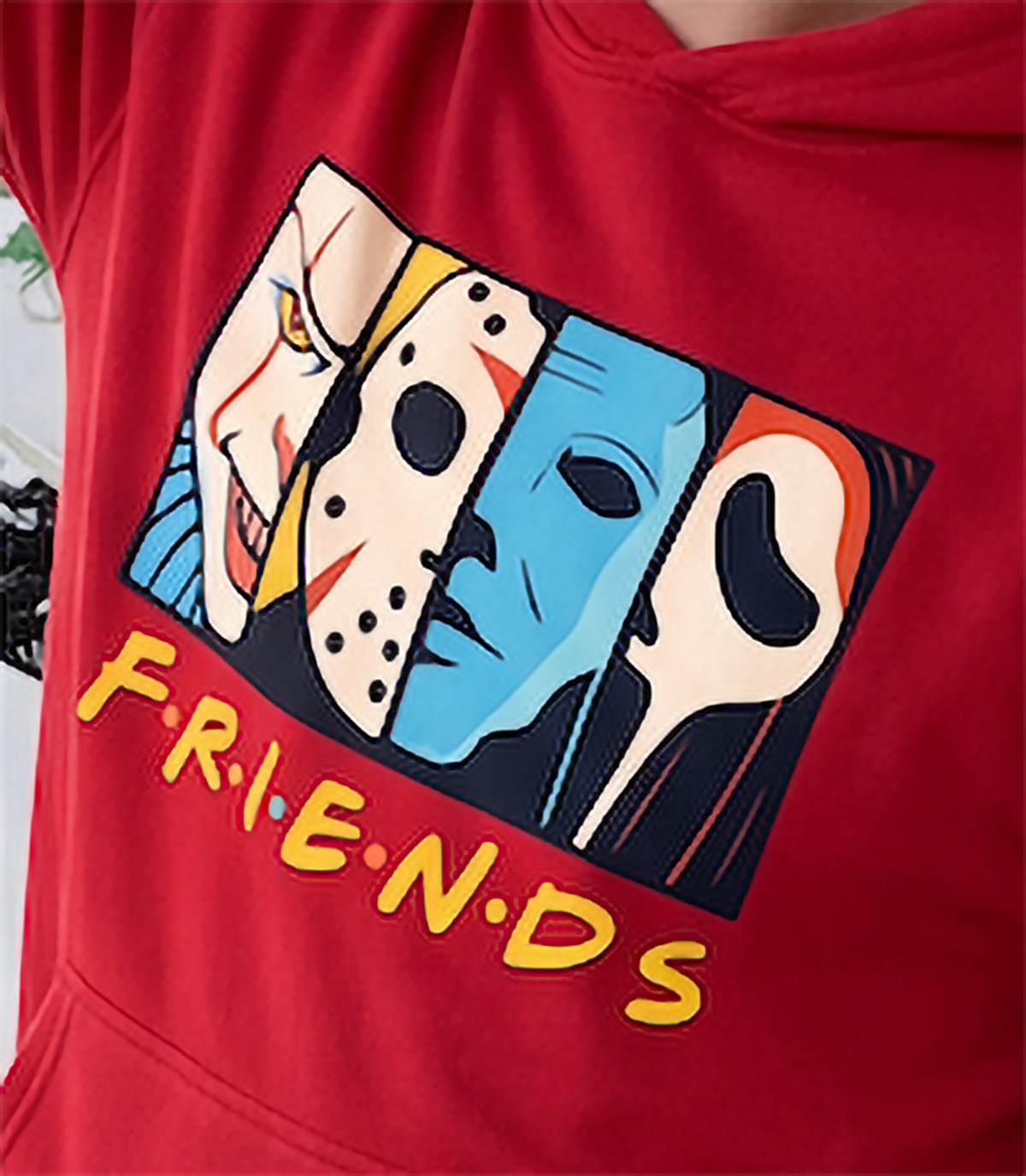 Close-up of colorful Horror Friends slasher movie graphic printed on red hoodie