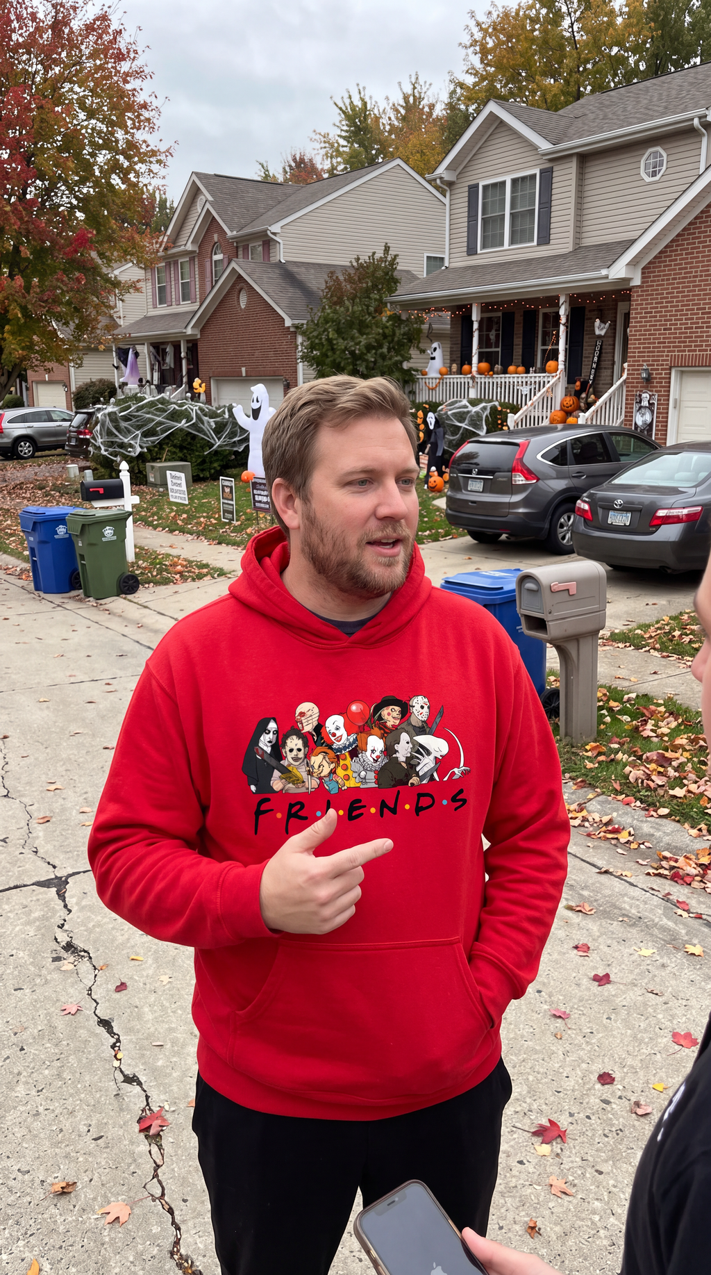 Woman wearing red Horror Friends hoodie for Halloween and spooky season