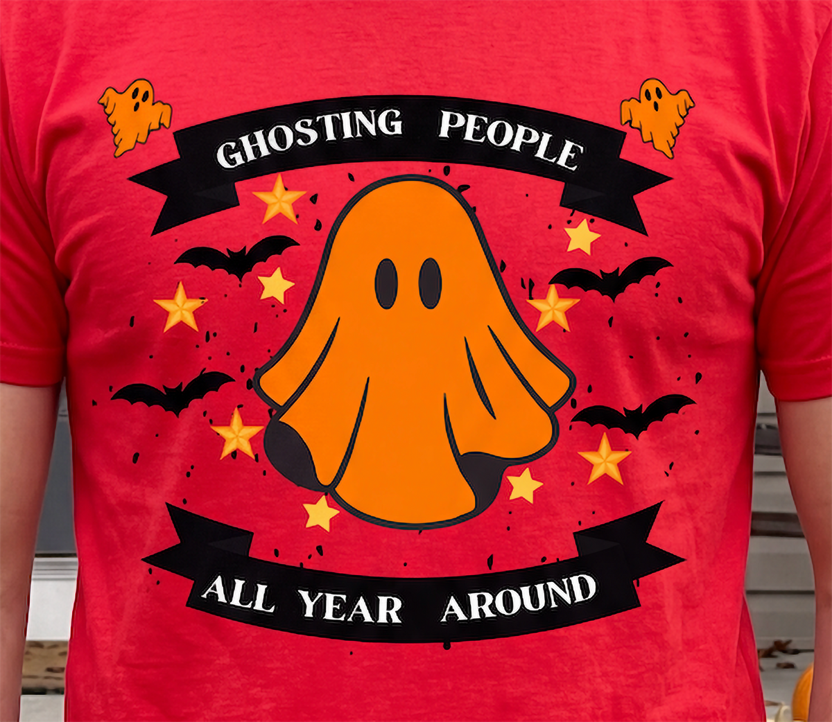 Close-up of red Ghosting People Halloween shirt with orange ghost and bats design